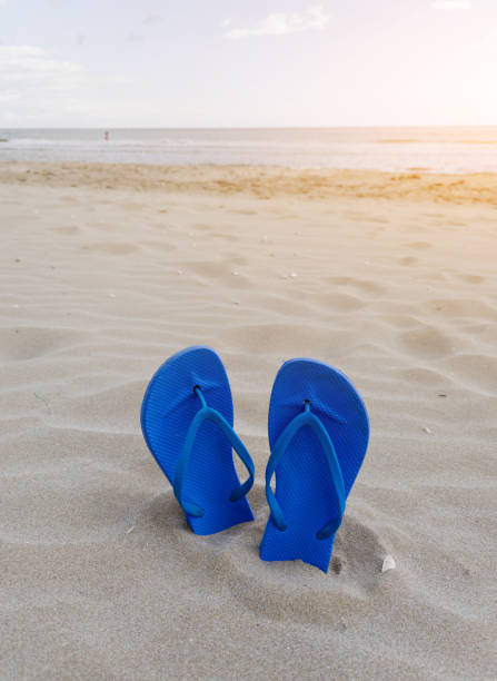 istock Blue blue flip flops slippers on beach. 2160551276
