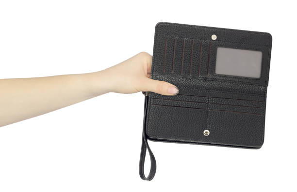 wallet with strap on hand in hand, outstretched hand with wallet with strap on hand isolated from background