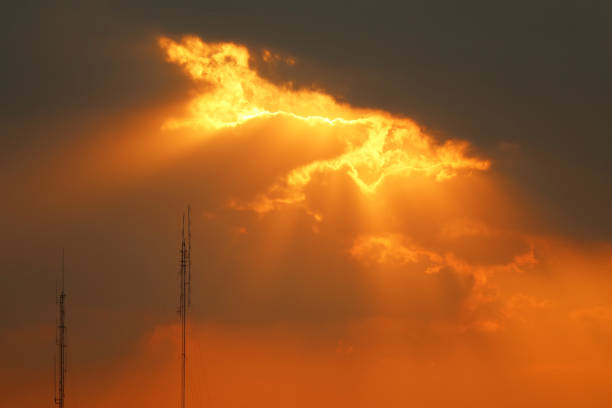 communication tower on highway at sunrise
