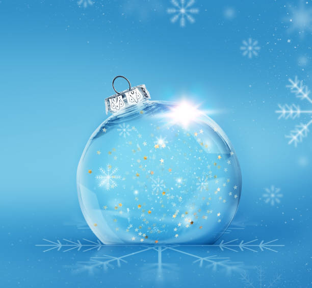 istock empty transparent Christmas ball with golden sparkling confetti inside on a blue background with snowflakes 2160554826
