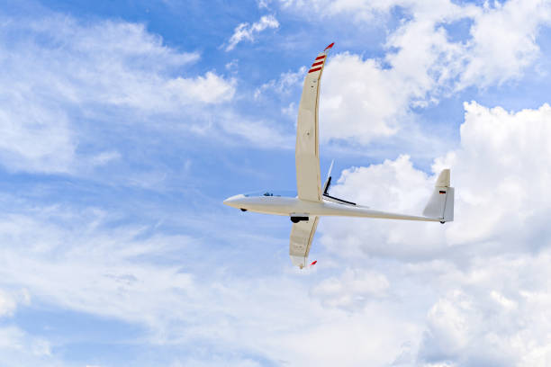 istock Light aircraft flying over blue sky 2160557534