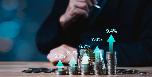 istock A man is sitting at a table with a jar full of coins 2160557553