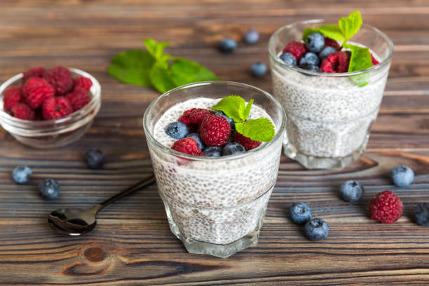istock Healthy breakfast or morning with chia seeds vanilla pudding raspberry and blueberry berries on table background, vegetarian food, diet and health concept. Chia pudding with raspberry and blueberry 2160558092