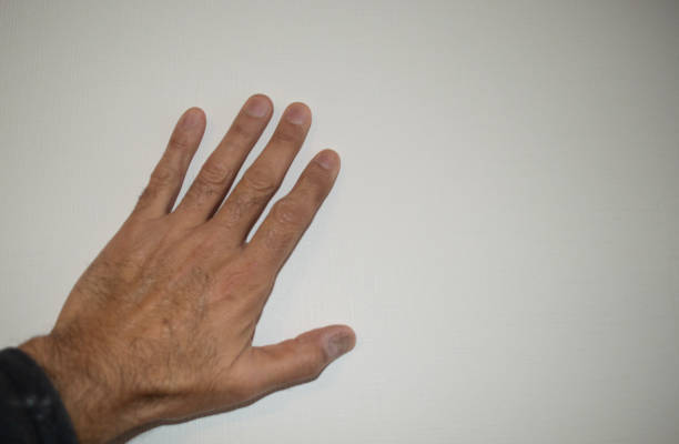 a hand of a latino man on a wall