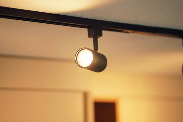 istock Close-up of modern ceiling lighting with lamp in a track system 2160559341