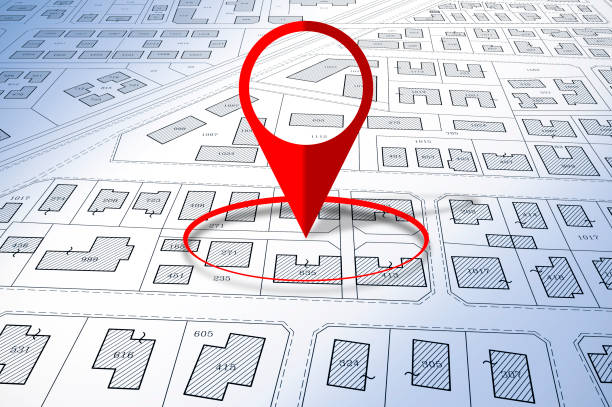 istock Building Activity with red location pin point against an imaginary General Urban Plan and cadastral map with zoning regulations, urban districts, urban destinations and land use - Real Estate concept 2160561209