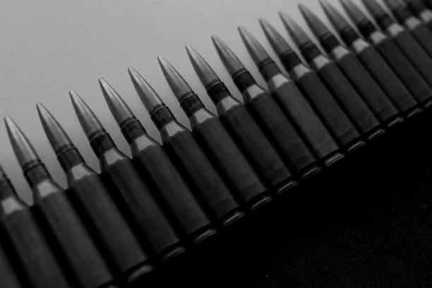 Two old bullets for automatic rifles of 5.45 and 7.62 caliber on a white background. Selective focus.