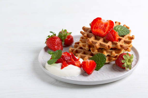 istock Delicious Belgian waffles with strawberries. 2160561830