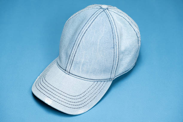 istock Blue denim cap close-up on blue background. 2160563991