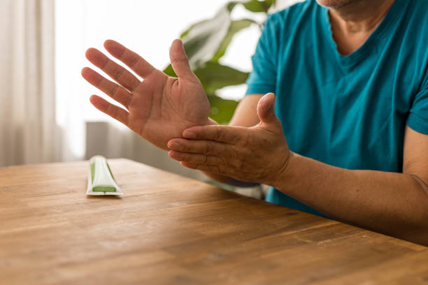 istock skin care, hands smeared with cream on dark background 2160564292