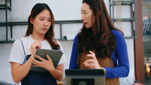 istock Barista Training New Employee on POS System 2160564373