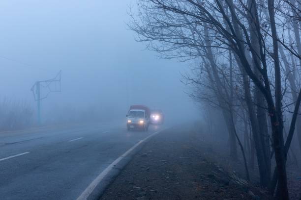 istock Vehicles Driving Through Thick Fog 2160564732