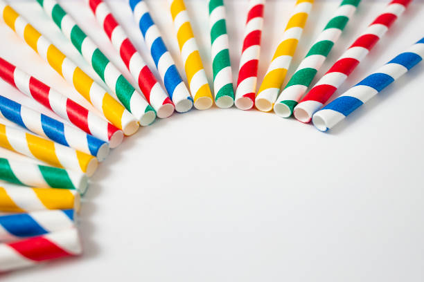 istock Colored paper straws arranged on white background, soft focus close up, party backdrop 2160565193
