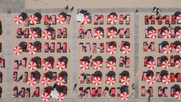 istock Red Umbrellas In the Beach Aerial 2160565253