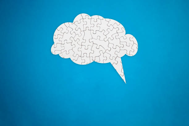 istock Brain shaped white jigsaw puzzle on blue background,  mental health and problems with memory concept 2160565432