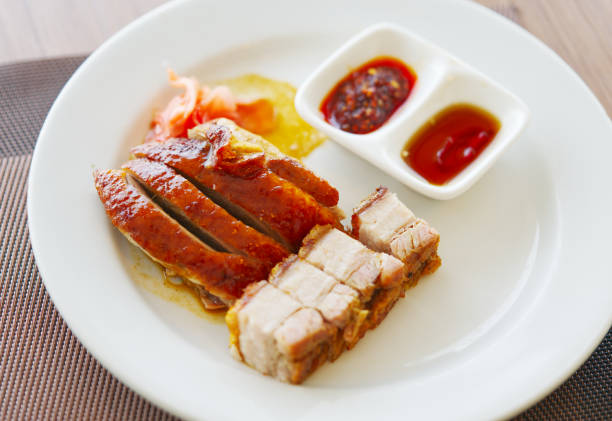 istock Roasted duck and crispy roasted pork together in a white dish 2160568594