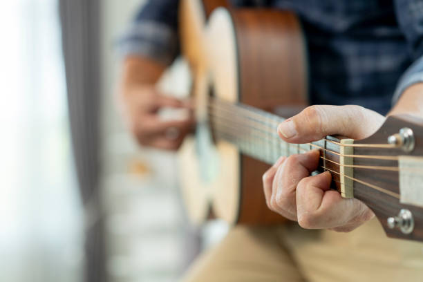 istock Asian mature man playing the guitar 2160571297