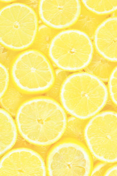 istock A slices of fresh juicy yellow lemons.  Texture background, pattern. 2160571389