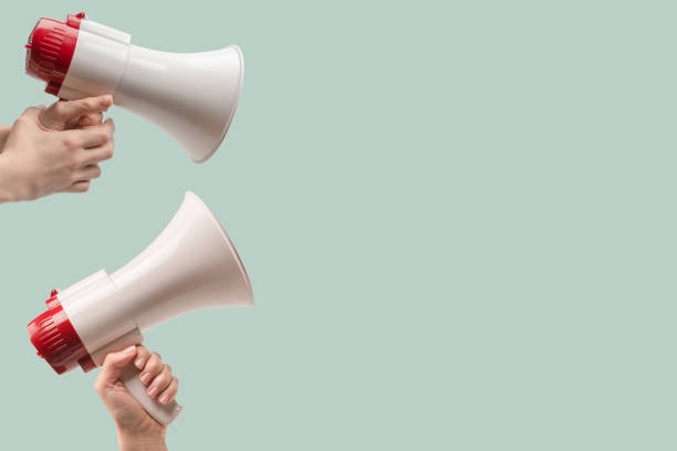 istock Megaphone in woman hands on a green background. 2160571397