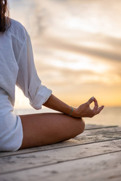 istock Unrecognizable woman meditating on the beach 2160571991