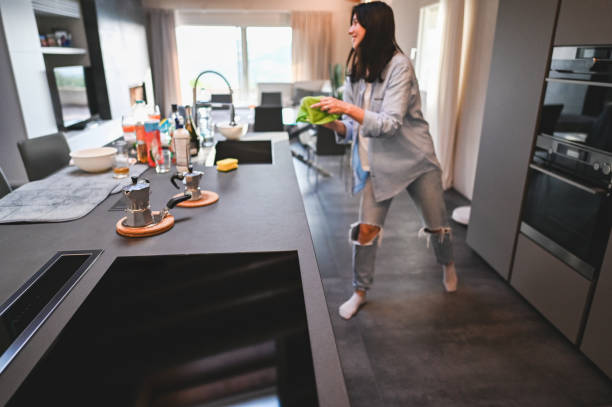 Cheerful woman cooking dinner.