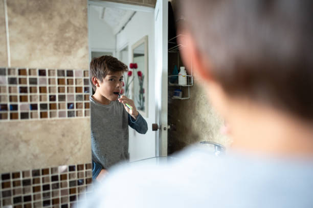 istock Child brushing teeth at home 2160574117
