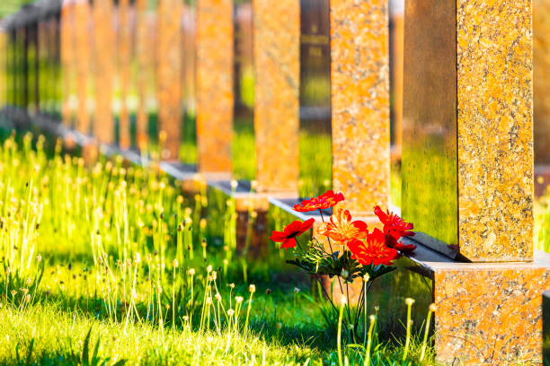 istock artificial flowers on the grave near the monument 2160574327