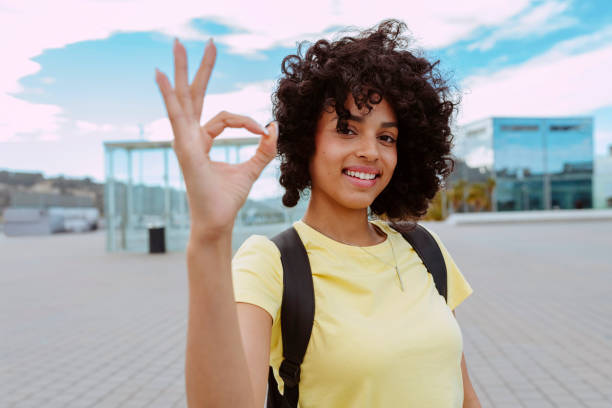 istock Multiethnic cheerful female student does ok sign with hand 2160575668