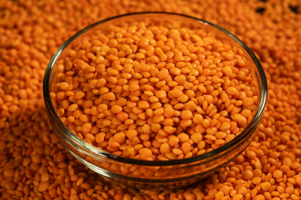 istock Red lentils in bowl on a lentils background 2160575817