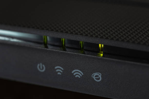Internet Router with green LED lights close up.