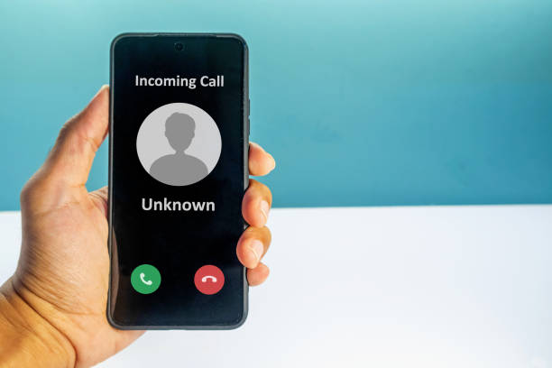 istock Hand holding a smartphone with incoming call from unknown number on the screen. Spammer incoming call concept. 2160576373