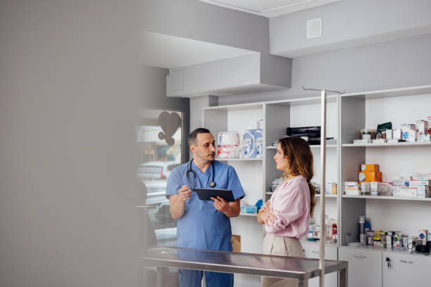 Doctor Consulting Cat Owner in Modern Veterinary Office
