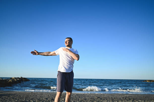 istock Athlete stretching arm against clear sky. 2160577049