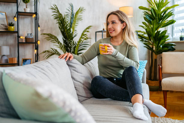 istock Young Woman Drinking Coffee On The Sofa At Home 2160578077