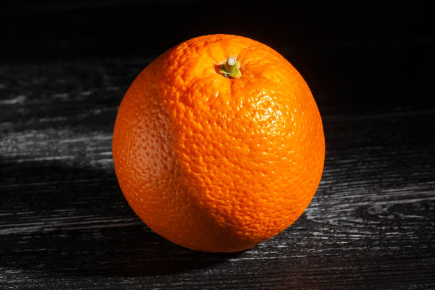 istock orange fruit on black wood 2160578612