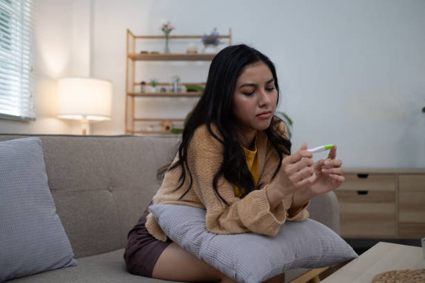 istock Sad unhappy woman holding a pregnancy test 2160579071