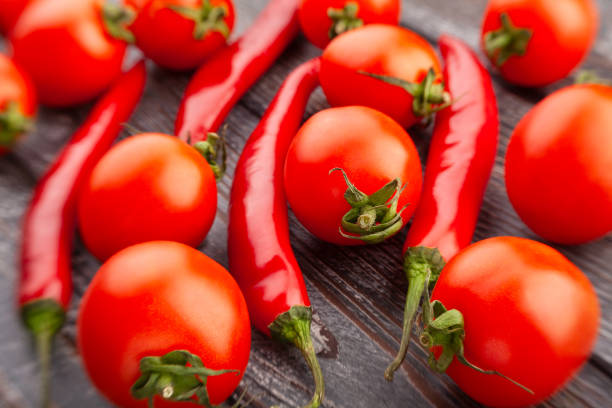 chili pepper cherry tomato on wood background