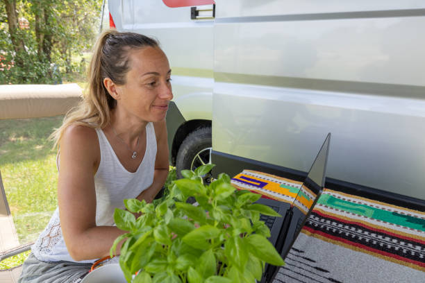 Woman Working on Laptop at Campsite