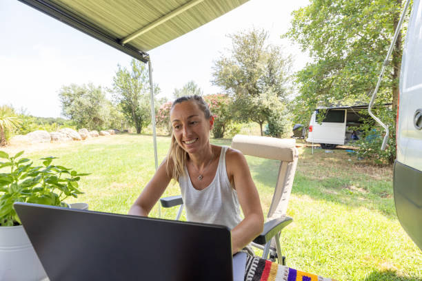istock Nature's Workspace: Woman Smiling with Laptop 2160581745