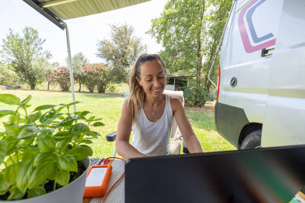 istock Nature's Workspace: Woman Smiling with Laptop 2160582003
