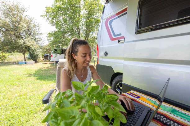 istock Woman Smiling While Working on Laptop Outdoors 2160582008