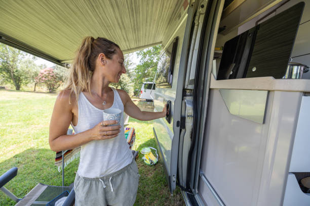 istock Woman with Coffee Mug by Campervan Door 2160582213