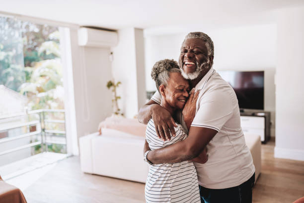 istock Elderly couple hugging at home 2160582553
