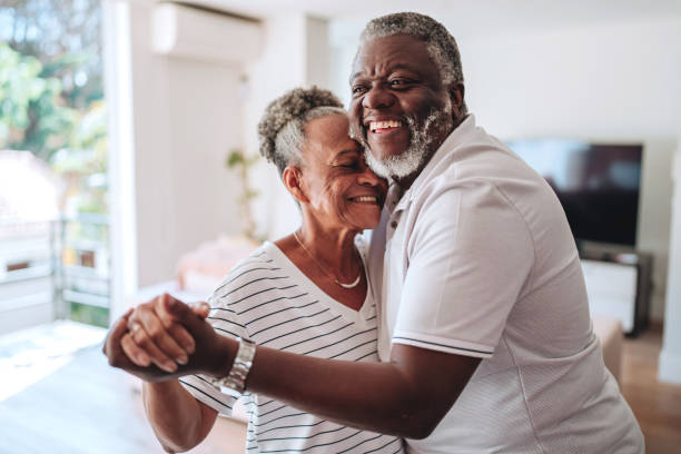 istock Elderly couple hugging at home 2160582557