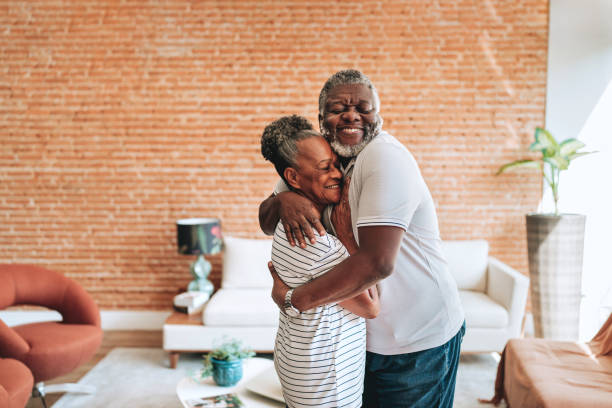 istock Elderly couple hugging at home 2160582566
