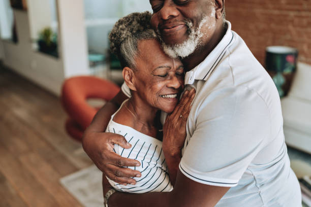 istock Elderly couple hugging at home 2160582567
