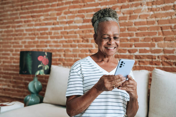 Portrait of an elderly woman using smartphone at home