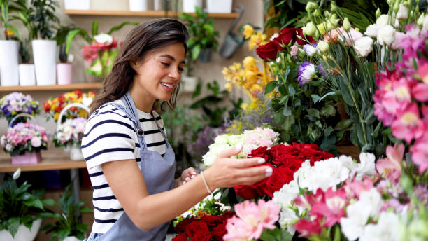 istock Young florist enjoying working with flowers 2160584578