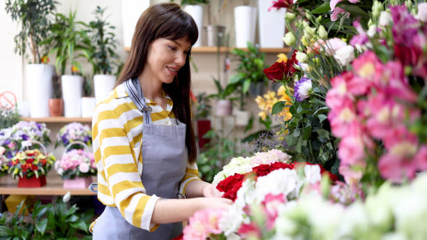 istock Florist arranging flowers at her store 2160584841
