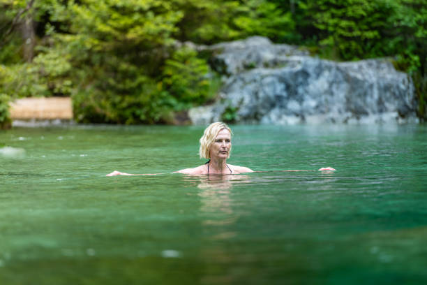 istock Woman in icy mountain water 2160584854